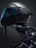 Easi Breezi filter unit mounted on a motorcycle with the braided air hose running up to a carbon full-face helmet