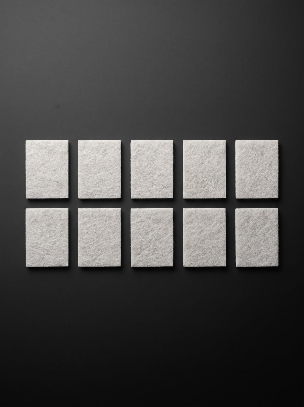 Ten Easi Breezi H11 HEPA replacement filter pads laid out in two rows of five