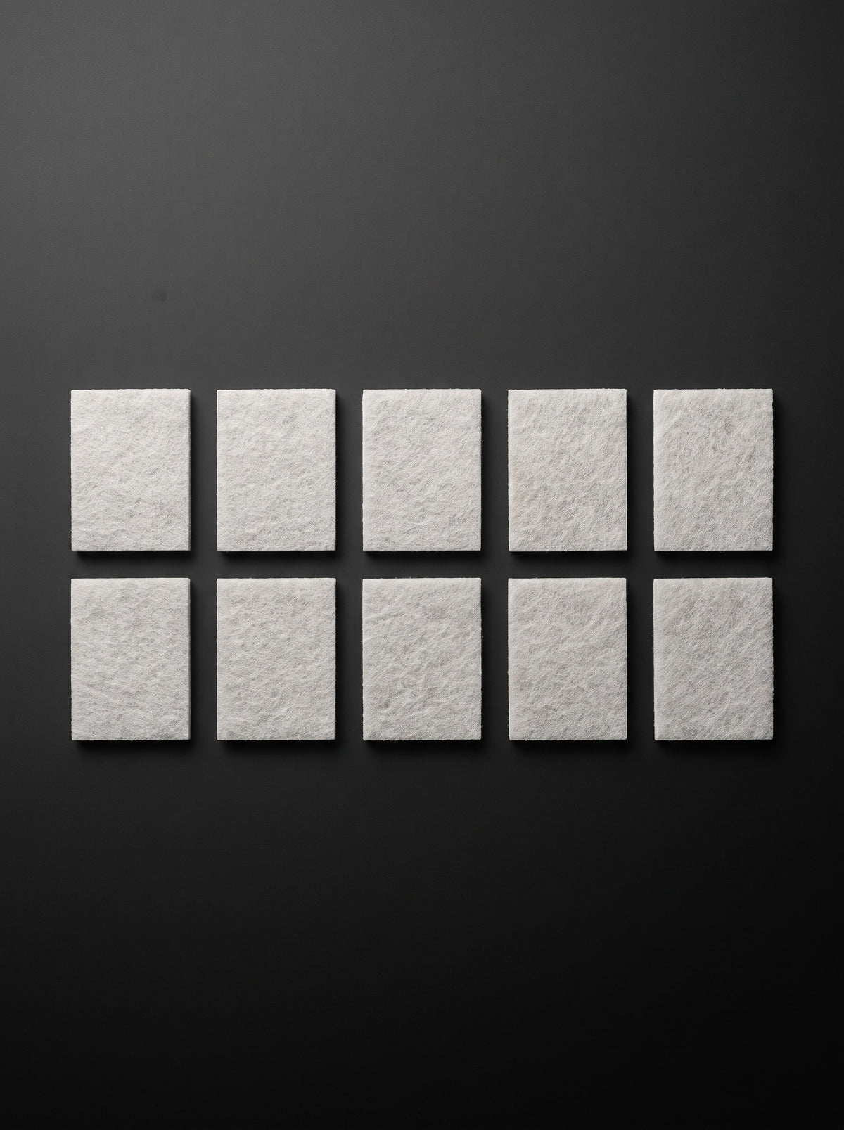 Ten Easi Breezi H11 HEPA replacement filter pads laid out in two rows of five