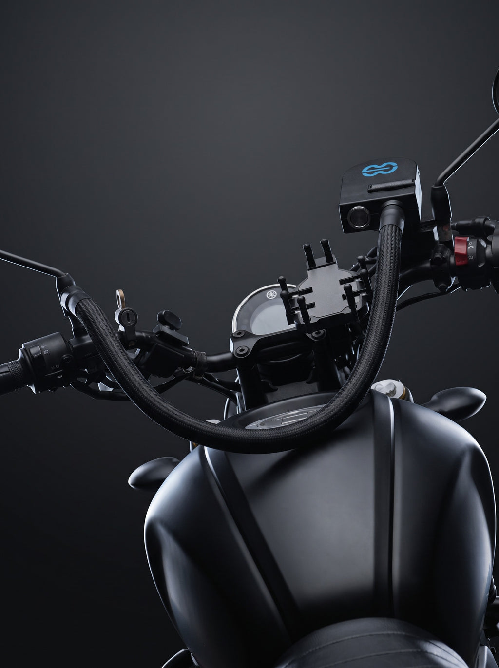 Rider's view of the motorcycle cockpit with the Easi Breezi unit and hose routed across the tank